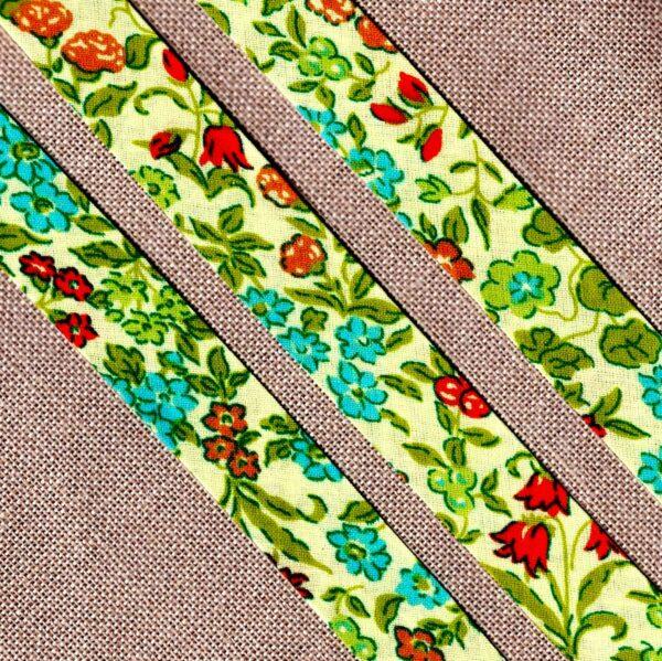 Ruban Biais fantaisie 20mm jaune clair avec des fleurs lime, vert, turquoise et orange rouge